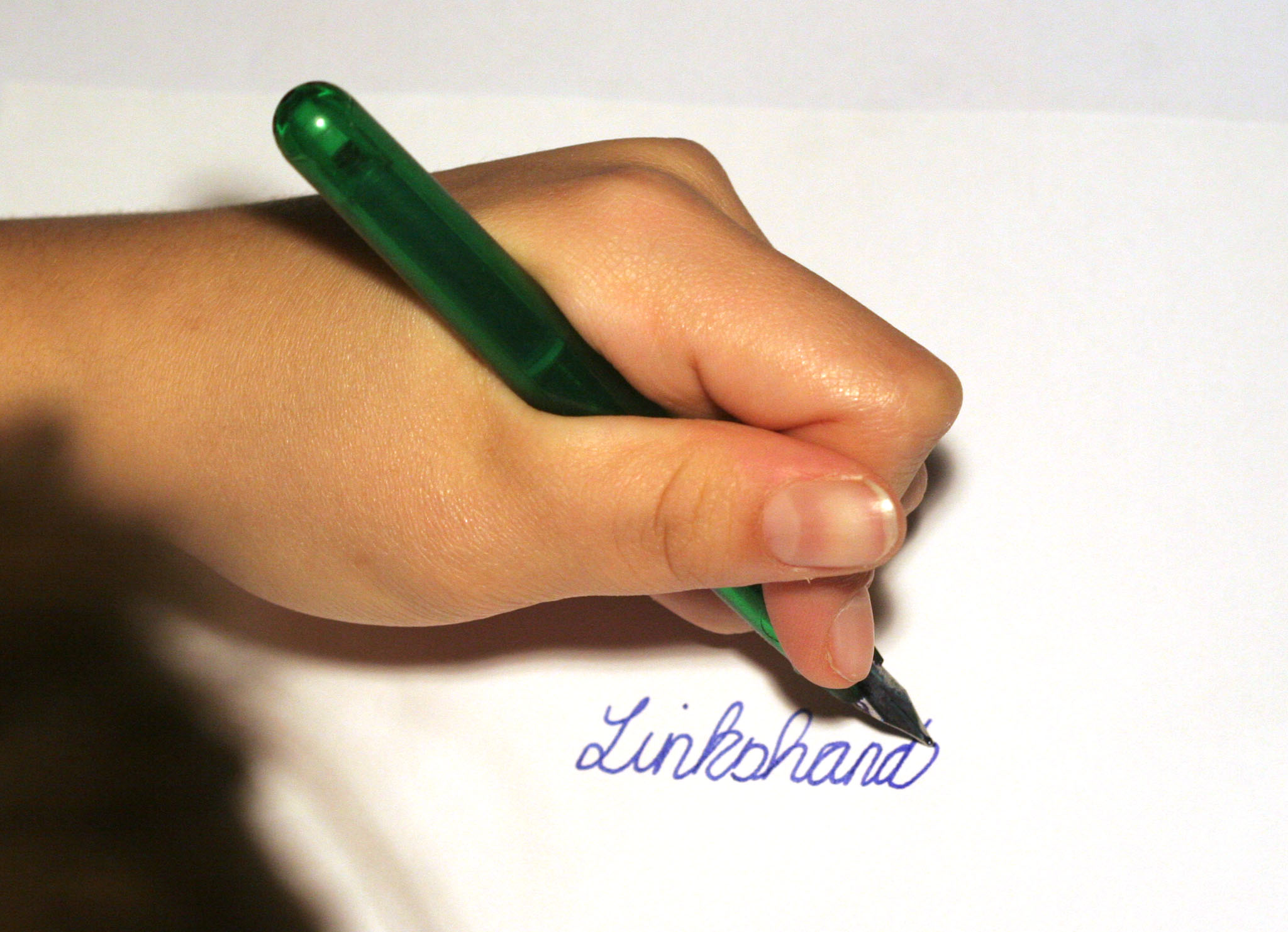 Left hand writing the Dutch word “Linkshandig” (left-handed)